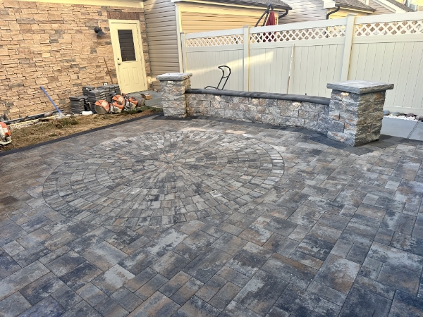 Stunning outdoor patio space with high-quality paver installation and surrounding landscape design
