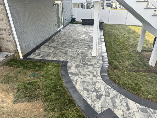 Beautiful retaining wall construction with natural stone creating terraced garden levels